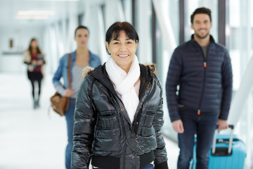 an elderly woman arrives at the airport