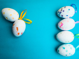 Easter eggs on blue background top view mockup