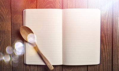 Empty notebook for recipes with spoon
