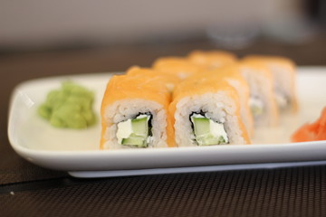 Delicious rolls with fish on a white plate