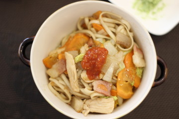 Delicious dish with noodles, chicken and vegetables in the restaurant