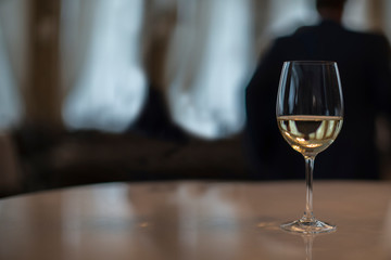 A glass filled with champagne on a table on a dark background