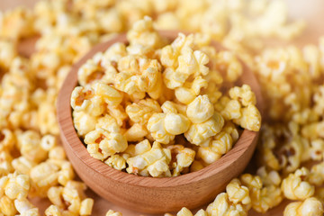 Sweet butter popcorn salt in wooden cup bowl and popcorn backgroubd top view