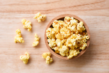Popcorn in wooden bowl and wood backgroubd top view / Sweet butter popcorn salt