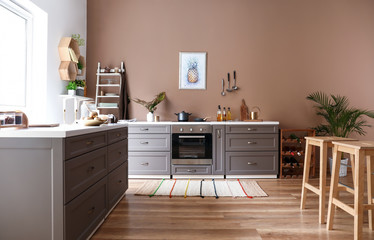 Modern interior of kitchen with stylish furniture