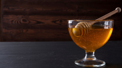Honey in a glass bowl. Copyspace