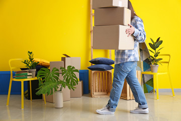 Woman with moving boxes in room