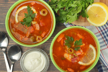 Two bowls with traditional Russian soup solyanka