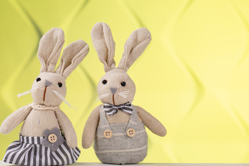 Two funny children toys. Funny toy rabbits on yellow background. DIY toys for kids