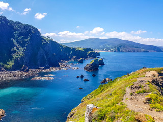 Fototapeta premium Hermitage of San Juan de Gaztelugatxe at the top of the island of Gaztelugatxe. Vizcaya, Basque Country (Spain). View of the Cantabrian Sea with blue sky.