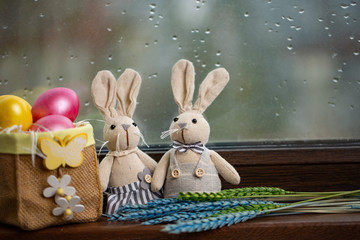 Happy Easter Background with colorful eggs in basket and hare. Table decorating for holiday.