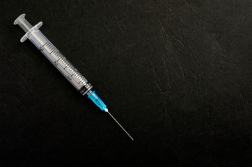 medical syringes on a dark background