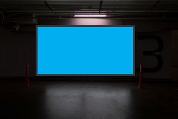 indoor car parking and empty blue billboard .Blank space for text and images.