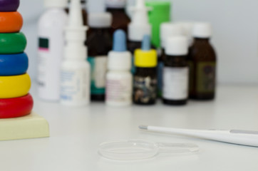 medicine bottles for children and a thermometer