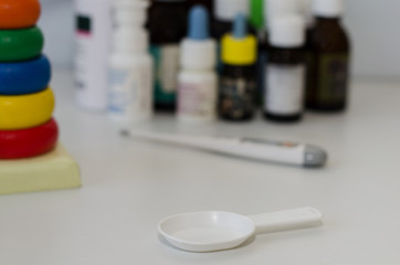 medicine bottles for children and a thermometer