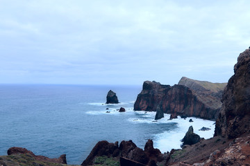 Fototapeta na wymiar Landscape of the coast of the island of Madeira on a cloudy day. Horizontal, nobody, side view, a lot of free space for text. Concept of nature