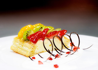 fruit cake with strawberry, kiwi, berry and peaches, raspberries, orange and other fruits