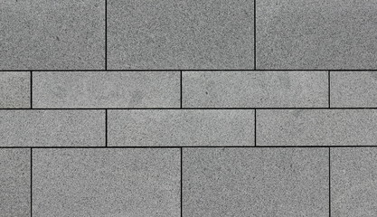 Background from plates of gray granite paving slabs