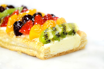 fruit cake with strawberry, kiwi, berry and peaches, raspberries, orange and other fruits