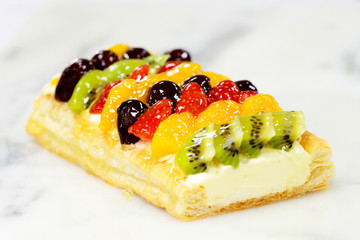 fruit cake with strawberry, kiwi, berry and peaches, raspberries, orange and other fruits