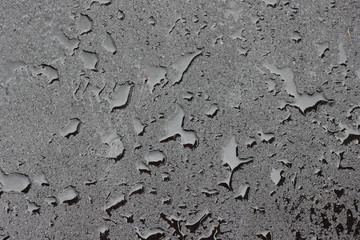 Water droplets on reflective wet black metal texture
