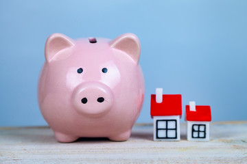 Pig piggy bank and two houses.