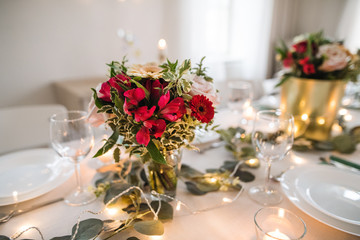 Table set for a meal indoors in a room on a party, a wedding or family celebration.