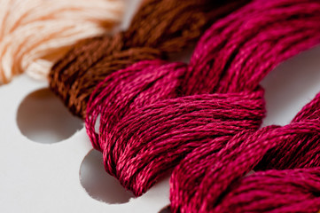 Thread for embroidery floss on paper base close-up shot