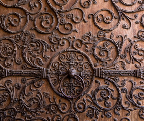 Door detail of Notre Dame de Paris Cathedral, Paris, France. Old wooden door with a metallic pattern close-up. The cathedral Notre-Dame de Paris