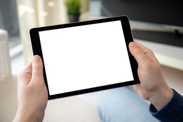 man hands holding computer tablet with isolated screen in room
