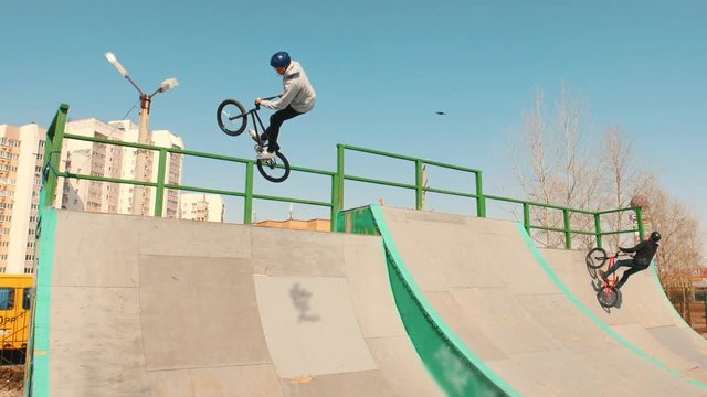 A bmx riders training their skills in the skatepark on a high speed. Jumping on a exalts