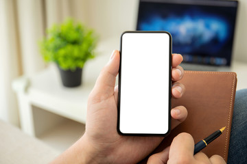 man hands holding phone with isolated screen in the room
