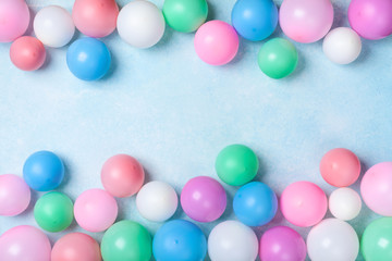 Colorful balloons frame on blue table top view. Festive or party background. Flat lay style. Birthday greeting card.