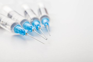 Hypodermic syringe. Syringes with blue needles. Medical Injectors.