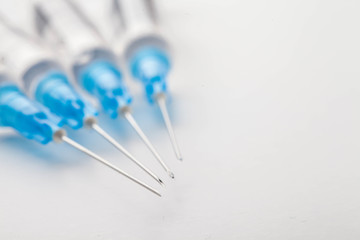 Hypodermic syringe. Syringes with blue needles. Medical Injectors.