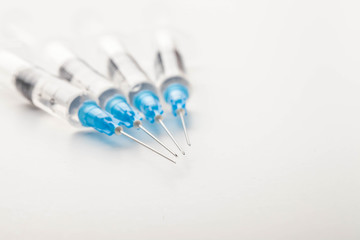 Hypodermic syringe. Syringes with blue needles. Medical Injectors.