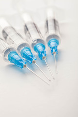 Hypodermic syringe. Syringes with blue needles. Medical Injectors.