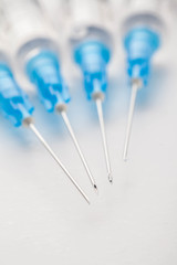 Hypodermic syringe. Syringes with blue needles. Medical Injectors.
