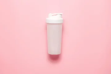 Fototapete White plastic sports shaker on pastel pink  background.  Trendy athletics and sport minimal  concept. Female fitness.Flat lay, top view.  © Nataliia