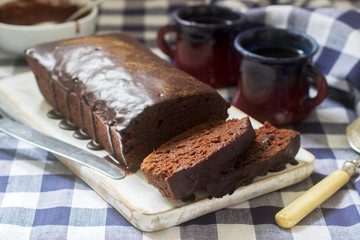 Vegan Mexican chocolate cake with chili, cinnamon and chocolate icing served with coffee.