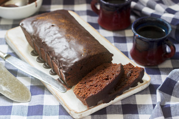 Vegan Mexican chocolate cake with chili, cinnamon and chocolate icing served with coffee.