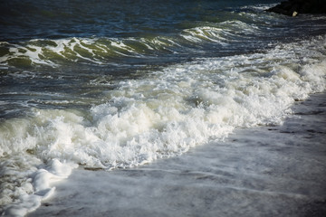 Beautiful beach on sunny day. Waves with foam on the sea. Holiday travel concept. Barcelona Spain views.