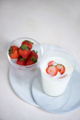 Strawberry homemade yogurt with fresh strawberries on white table