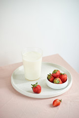 strawberry and yogurt on pink background