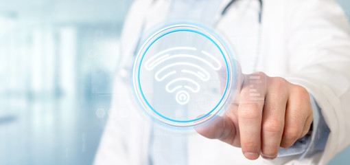 Doctor holding Wifi icon with stats and binary code 3d rendering