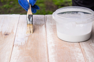 Man paints a white paint surface. Coloring boards.