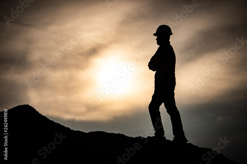 Concept Labor Day: Labor man standing with a warm sunset light