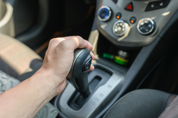 Naklejka premium Driver male hand holding automatic gear shift