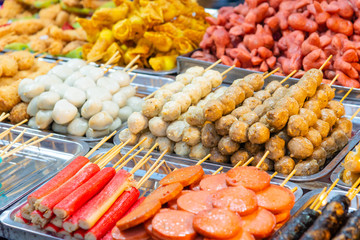Various Thai style grilled meatball on tray in street food market of Thailand
