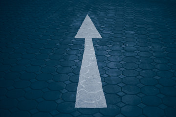 Asphalt road with an arrow up. Up arrow on gray background